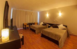 Postel nebo postele na pokoji v ubytování Gran Hotel Xalapa