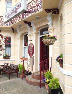 a building with potted plants on the front of it at Cavendish House Hotel in Great Yarmouth