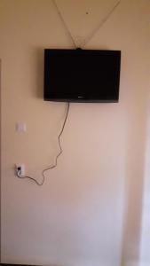 a flat screen tv hanging on a wall at Amir's Apartment in Nieuw Nickerie