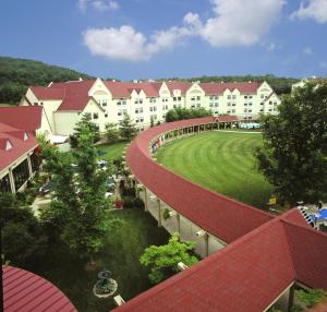 an aerial view of a building with a green yard at The Branson Hillside Hotel in Branson