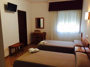 Posteľ alebo postele v izbe v ubytovaní Hostal Eden