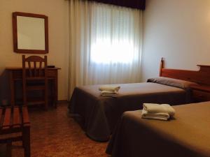 Posteľ alebo postele v izbe v ubytovaní Hostal Eden