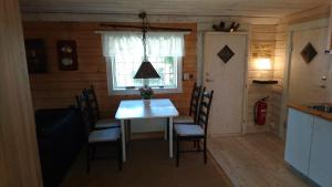 a dining room with a white table and chairs at Muskö Havsbad in Muskö Havsbad