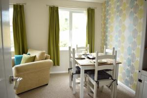 a dining room with a table and a chair at 103 Bewick Serviced Accommodation in Newton Aycliffe