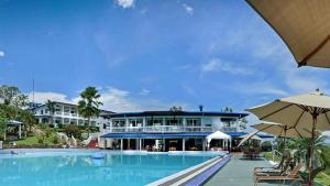 a resort with a swimming pool and a building at Cristal Ballena Boutique Hotel & Spa in Uvita