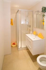 a white bathroom with a shower and a sink at Appartement Rofan in Pertisau