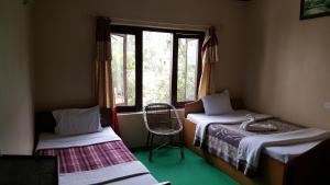 Postel nebo postele na pokoji v ubytování Nepali Cottage Guest House