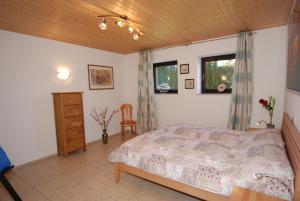 a bedroom with a bed and a wooden ceiling at Haus über den Dächern von Heiligenhafen in Heiligenhafen