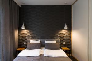 Een bed of bedden in een kamer bij Homewell Apartments Maraton Gardens