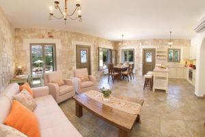 a living room with a couch and a table at Forest Villas Kefalonia in Logaráta