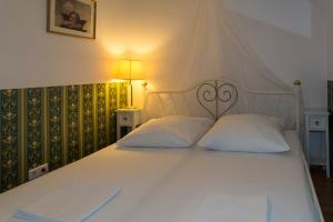 a large white bed with two pillows on it at Haus zum Einhörnle in Konstanz