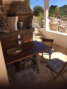 a table and chairs in a patio with a stone oven at Dream house in Zaglav +41 photos