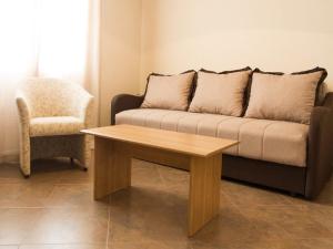 a couch and a chair in a living room at Hortus Apartments in Sveti Stefan