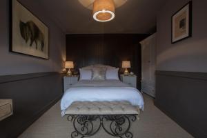 The Minster Arms في ويمبورن مينستر: غرفة نوم فيها سرير ومقعد