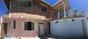 a house with two garage doors in front of it at Residencial Samuel in Bombinhas
