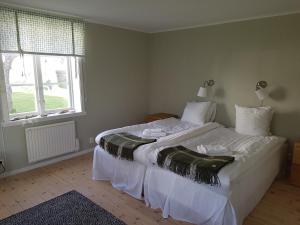 a bedroom with two beds and a window at Skänninge Bed & Breakfast in Skänninge