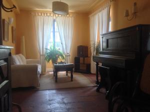 a living room filled with furniture and a piano at Camino Condal in Oña
