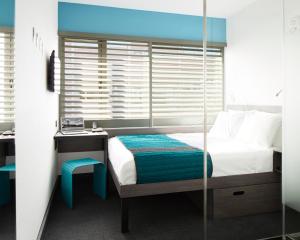 Ein Bett oder Betten in einem Zimmer der Unterkunft Pod Brooklyn