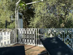 a white fence with a bench on a patio at Muta House in Sorrento