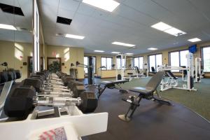 a gym with a row of treadmills and machines at RiverStone Condo Resort & Spa in Pigeon Forge