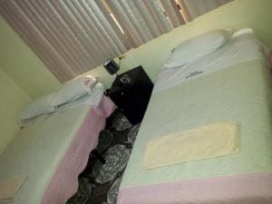 Säng eller sängar i ett rum på Hostal David Alejandro
