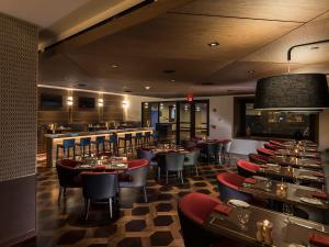 a restaurant with tables and chairs and a bar at Seneca Niagara Resort & Casino in Niagara Falls