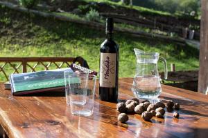 a bottle of wine sitting on a wooden table at Otardi in Asteasu