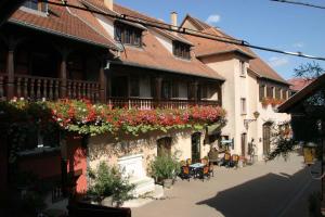 a building with flowers on the side of a street at Chambres d'hôtes Ruhlmann in Dambach-la-Ville