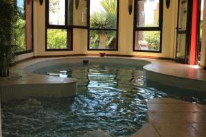 a swimming pool in a house with windows at Luxury house in the heart of Tenerife in Las Lagunas