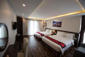 Postel nebo postele na pokoji v ubytování Sapa Wings Hotel
