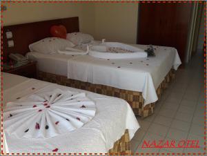 Un ou plusieurs lits dans un hébergement de l'établissement Nazar Hotel