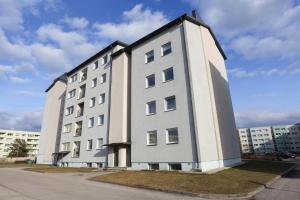 a large white building with aventh floor at Studio apartment in Pärnu