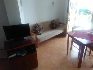 a living room with a couch and a table at Yialos Apartments in Pissouri