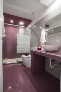 a bathroom with a toilet and a sink and a shower at Paxos Bay Studios in Gaios