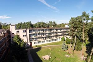 an external view of a building with a garden at Osrodek Rehabilitacyjno-Wypoczynkowy FAMA-STA in Mrzeżyno