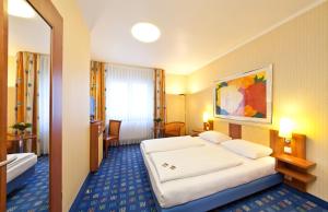 Cama o camas de una habitación en Novum Hotel Boulevard Stuttgart City