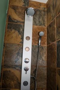 a shower with a shower head and a showertaining at Greenways Emerald Bay in Strand