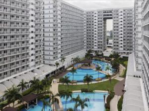 an aerial view of a large apartment complex with two pools at Luxury Condo with Pool View at Shell Residences in Manila