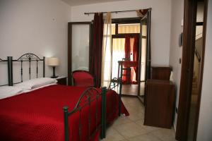 a bedroom with a red bed with a red blanket at Residence Angelica in Oria