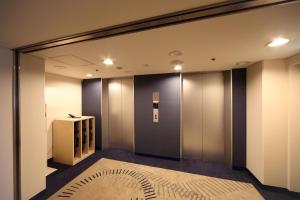 a elevator lobby with a large glass wall at Kobe Sannomiya Tokyu REI Hotel in Kobe