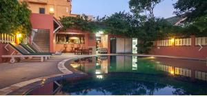 a swimming pool in front of a house at Takiab Beach Resort in Hua Hin