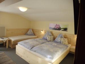 a bedroom with a bed and two tables in it at Haus Rohregger in Mittersill
