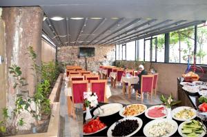 a restaurant with many plates of food on tables at Sun Comfort Hotel in Istanbul
