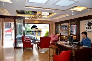 a man sitting at a desk in a restaurant at Sun Comfort Hotel in Istanbul