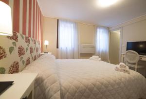 ヴェネツィアにあるカーサ デッレ オルテンシーのベッドルーム(大型ベッド1台、テレビ付)