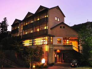 a large building with lights in front of it at Kirishima miyama hotel in Kirishima