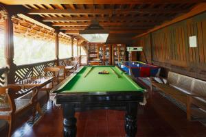 a pool table in a room with tables and chairs at The Travancore Heritage Beach Resort in Kovalam