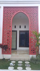 a red door of a building with at Villa Zam Zam Syariah in Puncak