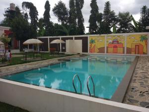 a swimming pool with a mural on the side of a building at Villa Zam Zam Syariah in Puncak