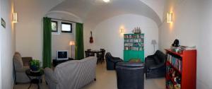 パラフルジェイにあるAlberg Solidança Hostelのリビングルーム(ソファ、椅子、テーブル付)
